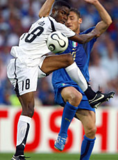 Eric Addo of Ghana (L) vies with Francesco Totti of Italy during the 2006 World Cup. Italy defeated Ghana 2-0. (PATRICK HERTZOG/AFP/GETTY IMAGES)