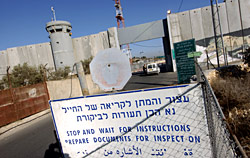 A sign warns cars to stop for inspection at the Israeli security wall in Bethlehem on December 20, 2006 (UPI Photo/Debbie Hill)